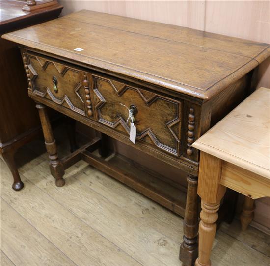 A 1920s Jacobean revival oak side table, W.106cm
